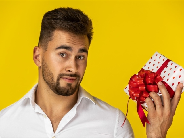 Man with a gift on a yellow background