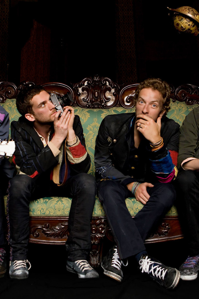 Coldplay sitting on the couch