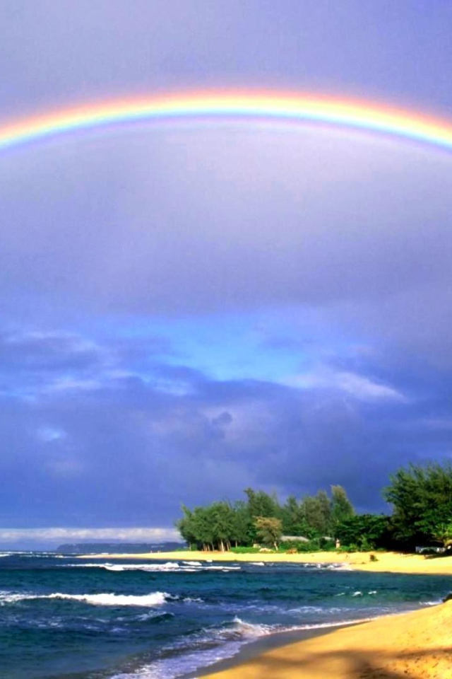 Rainbow over the sea and the beach