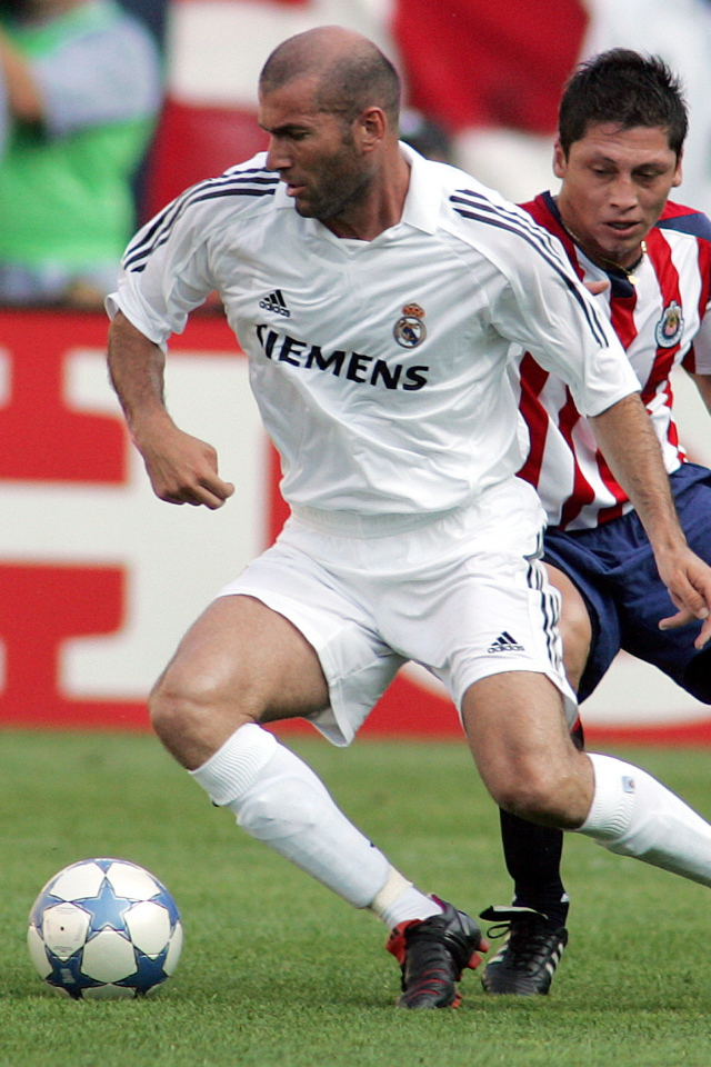 Легенда футбола Зинедин Зидан передавая мяч