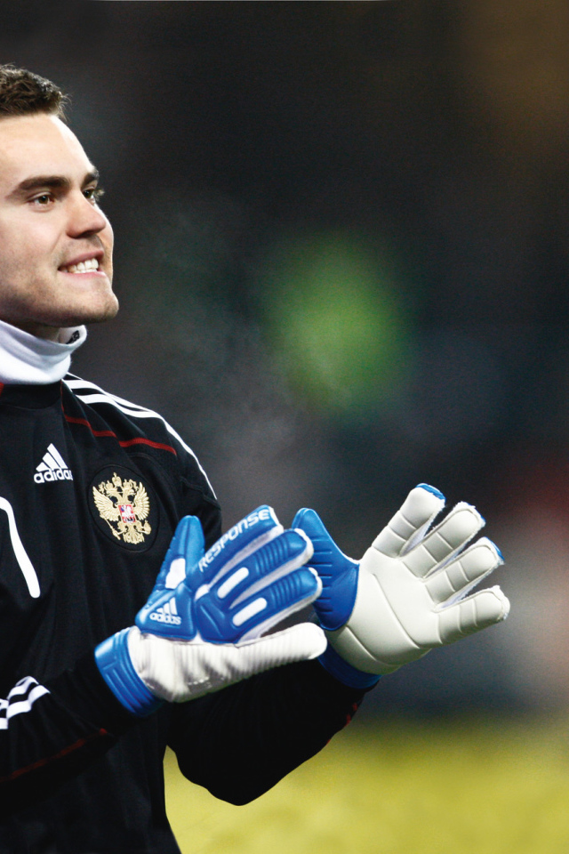 The player CSKA Moscow Igor Akinfeev is catching a ball