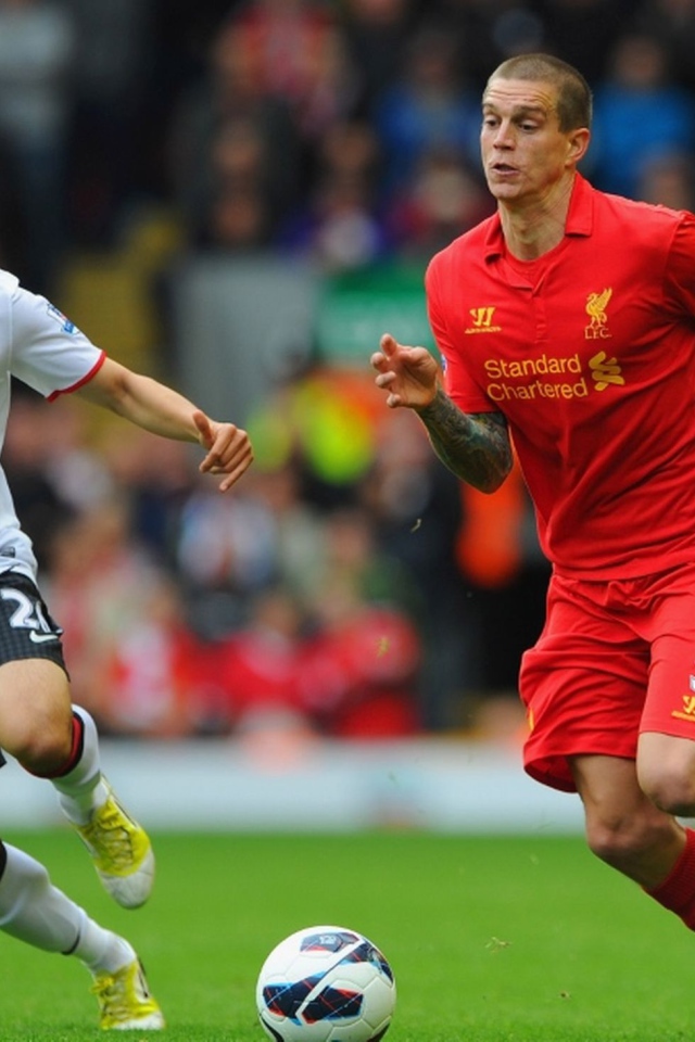 The player of Liverpool Daniel Agger is running forwards to the ball