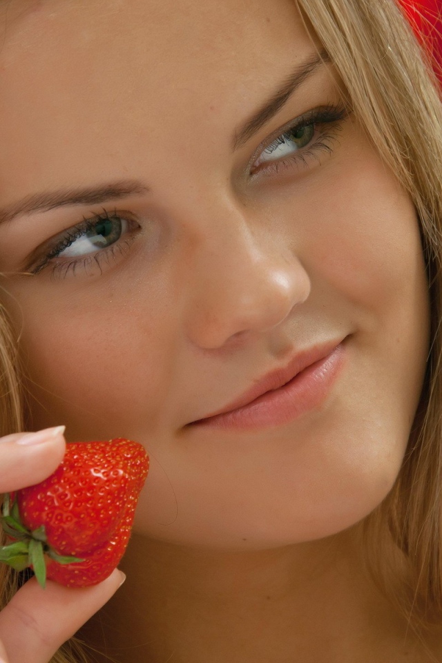Strawberry in the girl's hand