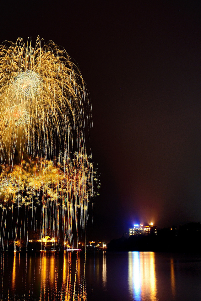 Праздничный фейерверк отражается в воде
