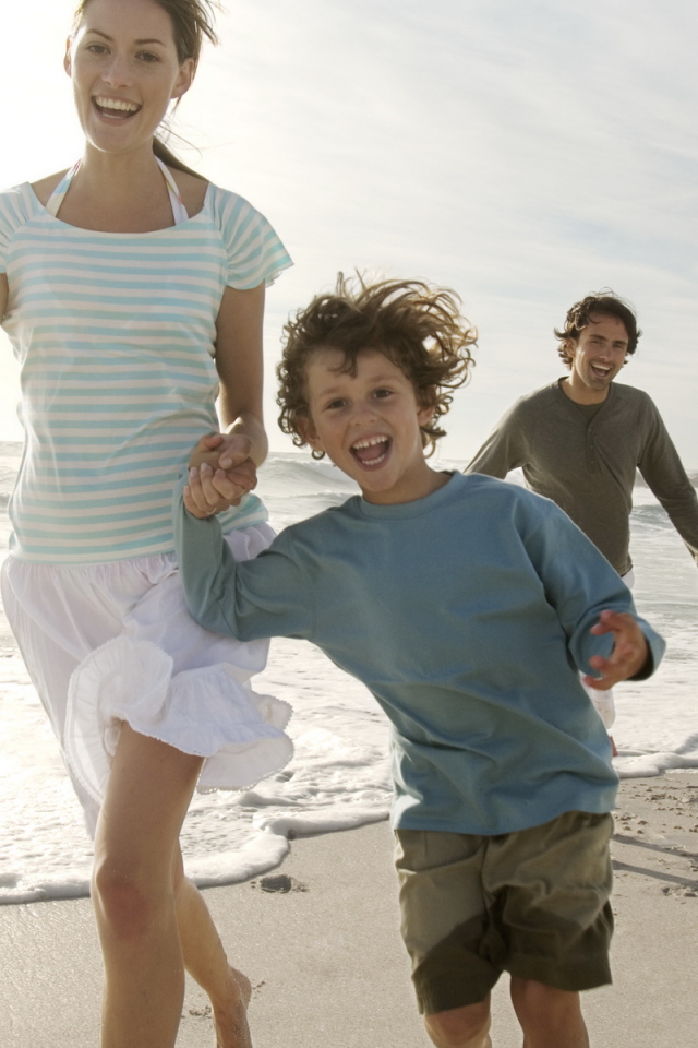 Семья гуляет на пляже