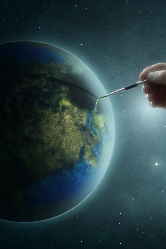 Рука рисует на планете