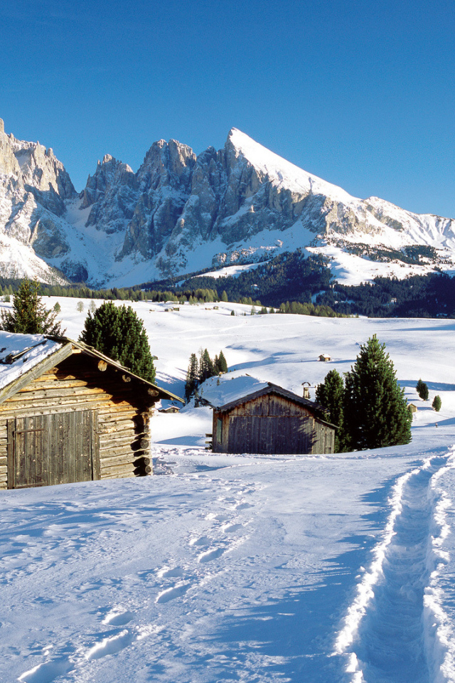 Дома на фоне гор на горнолыжном курорте Валь Гардена, Италия