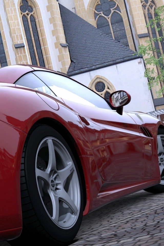 Красный спортивный автомобиль на площади у собора