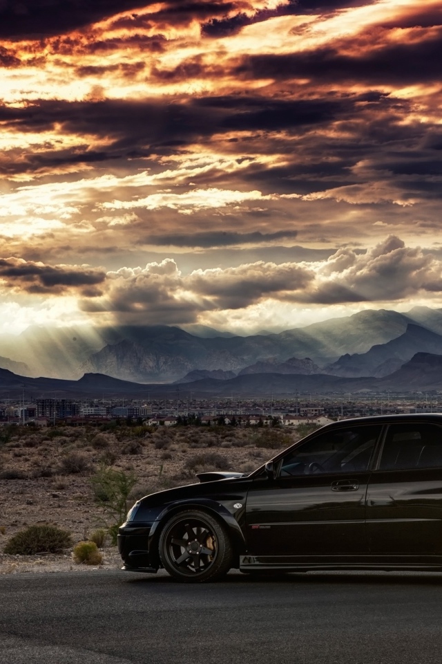 Черный Subaru WRX ST на фоне равнины