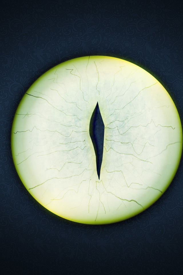 Круглый зеленый глаз на черном фоне