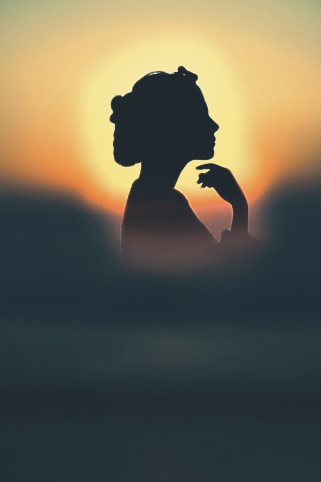 Silhouette of a girl in the sun
