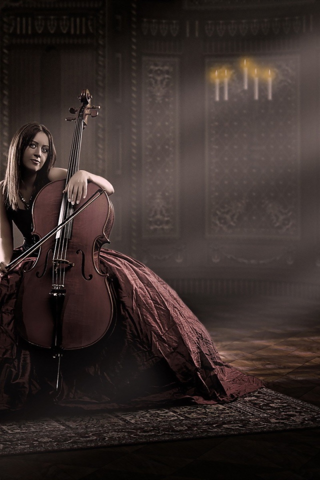 Девушка в роскошном платье играет на виолончели