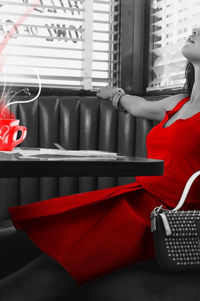 Girl in red dress sitting in a cafe