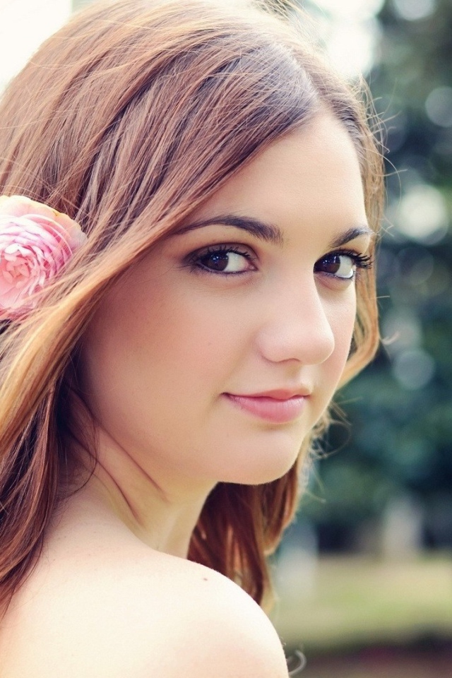 Девушка модель с розовым цветком в волосах