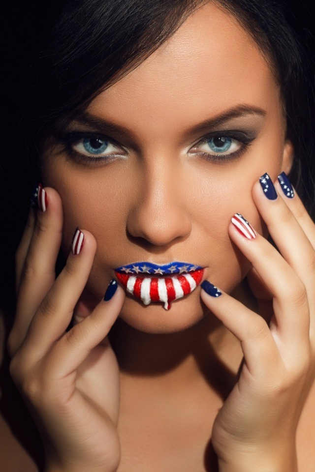 Lips and nails of the girl painted in colors of the flag