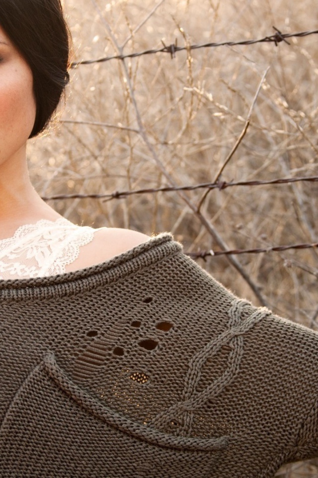 Девушка у забора из колючей проволоки