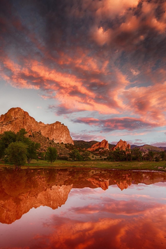 Облака отражаются в коричневой воде озера