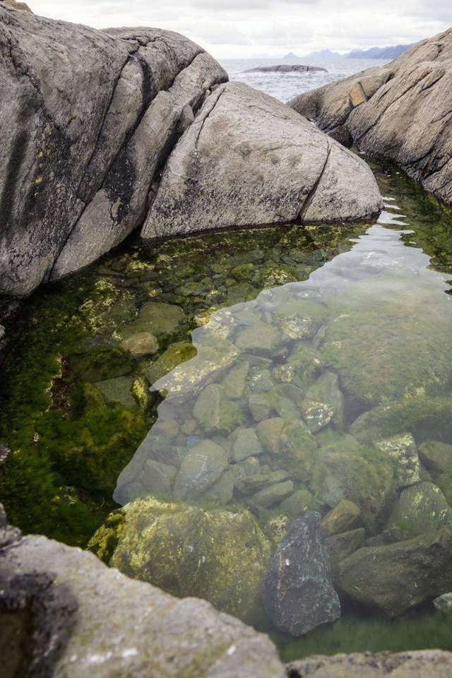 A small lake in the rocks near the shore