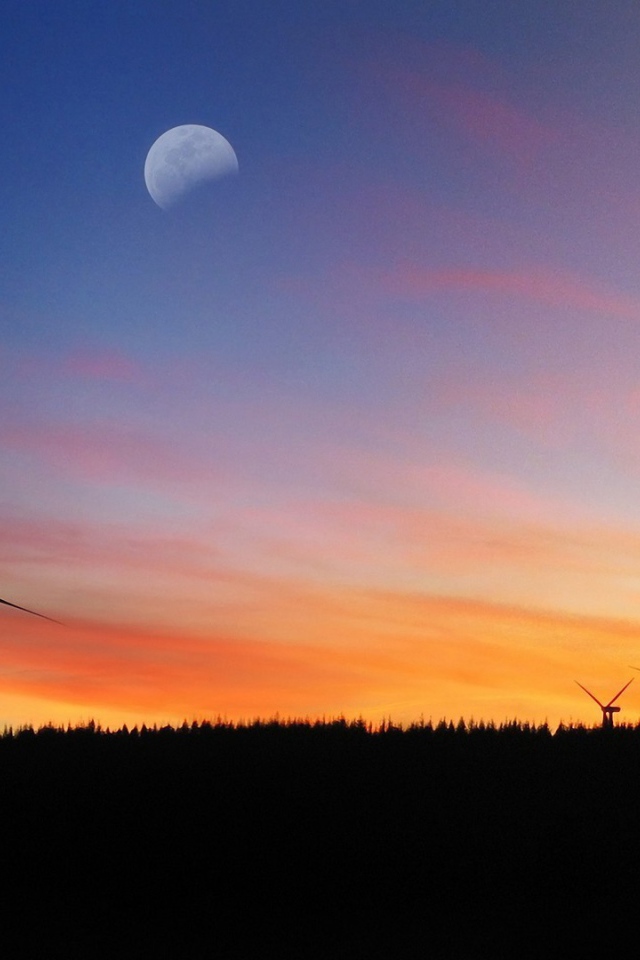 Силуэты ветряков на фоне заката