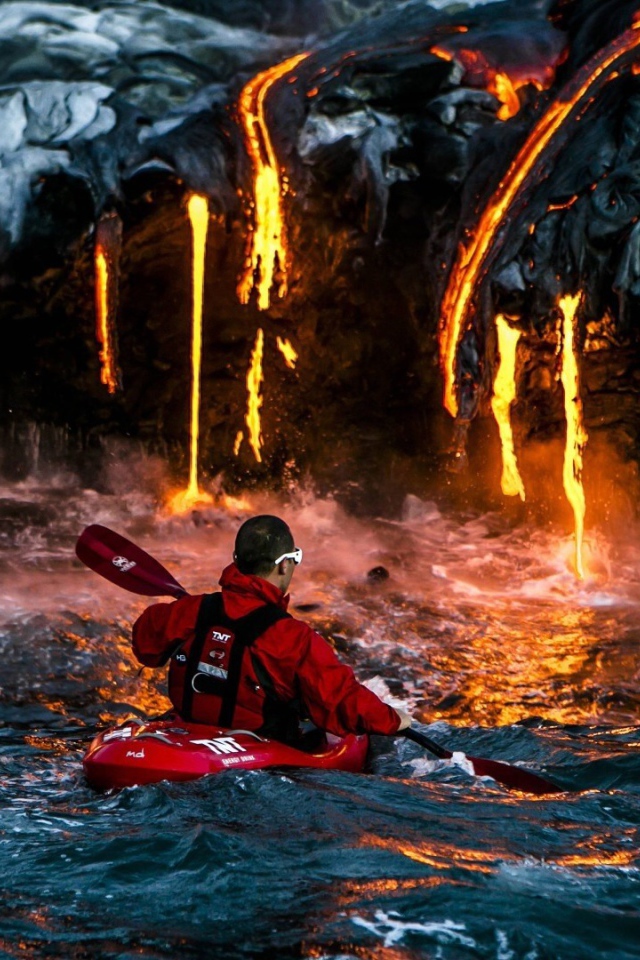 Человек на фоне лавы, стекающей в море
