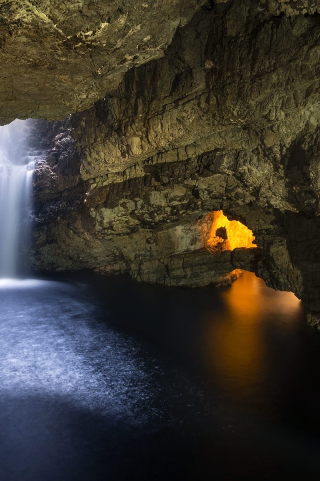 Waterfall in a stone cave in Scotland