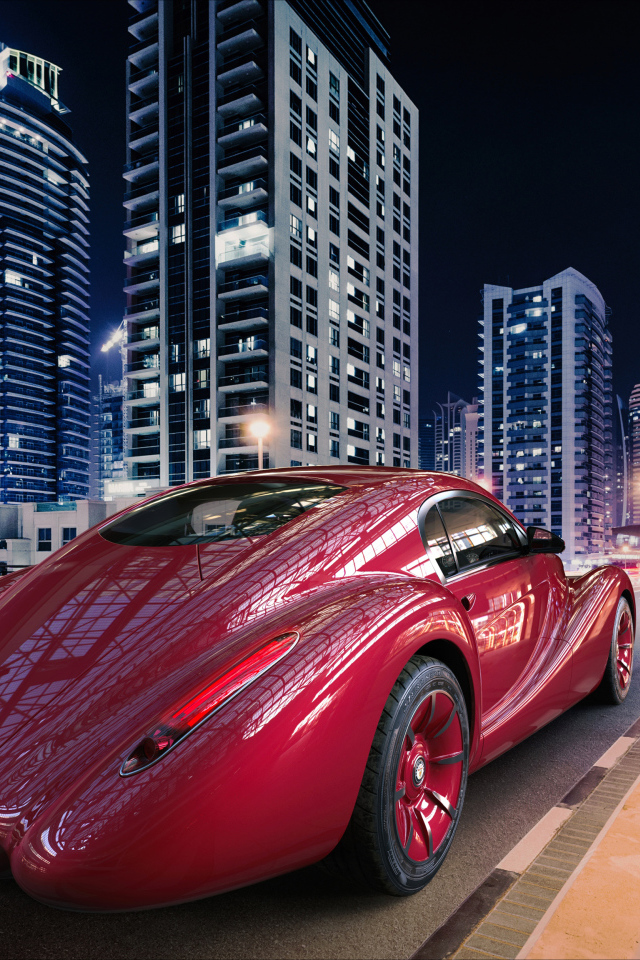 Необычный красный автомобиль Eadon Green Black Cuillin на фоне города 