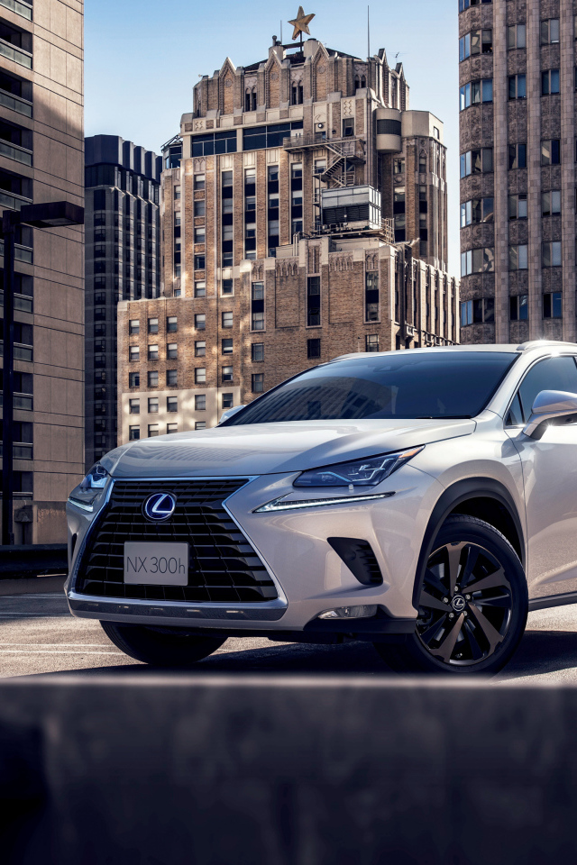 Белый автомобиль  Lexus NX 300h, 2018 на фоне домов