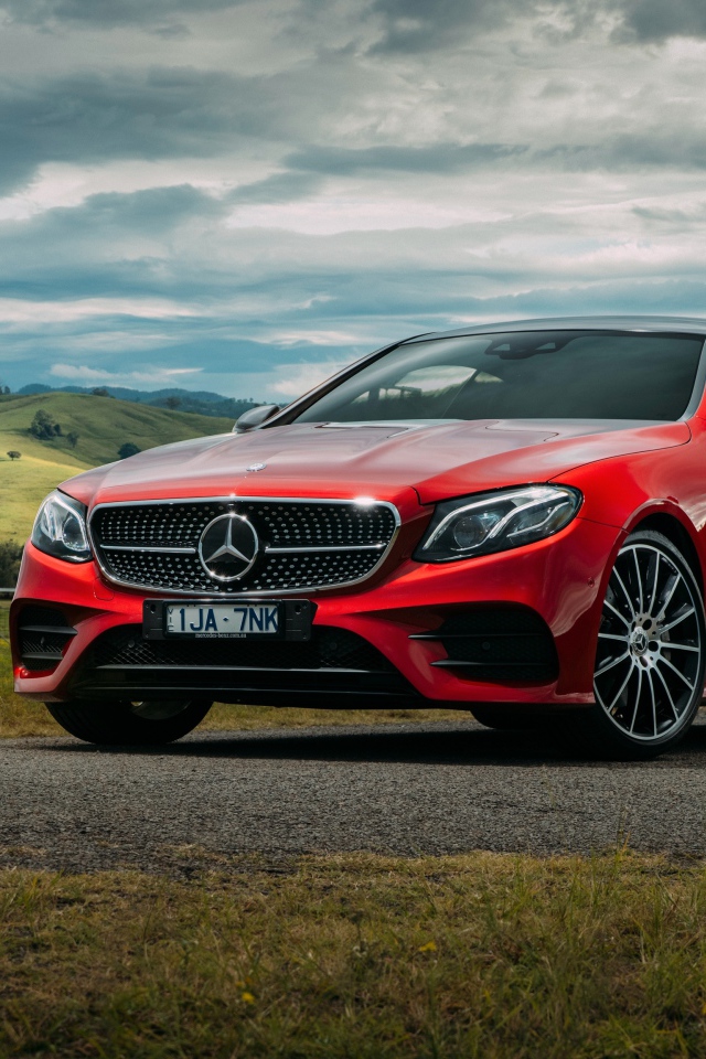 Красный автомобиль Mercedes-Benz E-Class на фоне природы