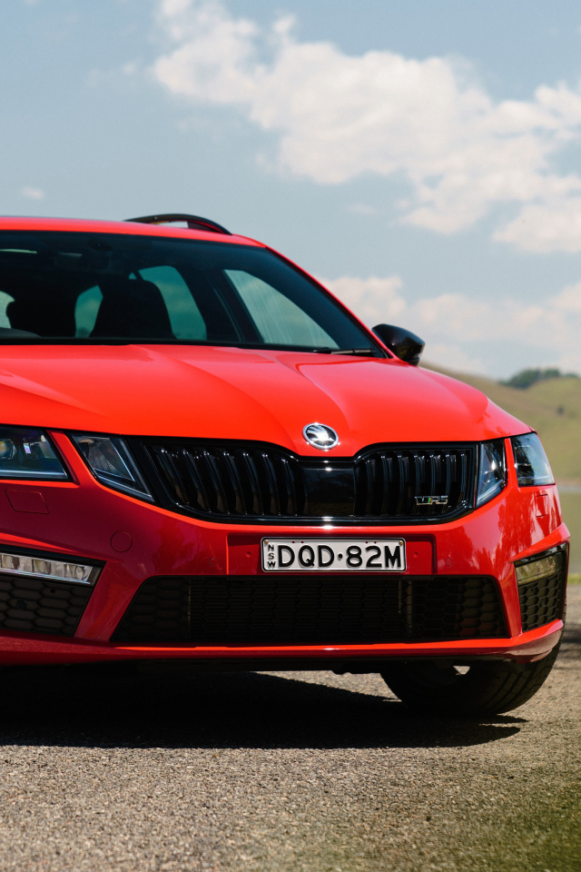 Quick red car Skoda Octavia RS 245 Wagon on the sky background