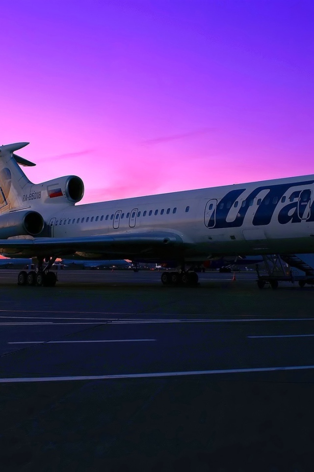 A passenger plane Tu-154 UTair Russian airline on the sunset background