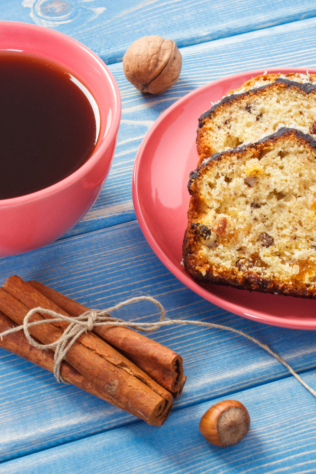 Кекс с корицей, орехами и курагой на столе с чашкой чая