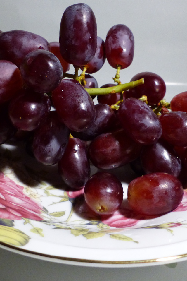 Розовый виноград на тарелке крупным планом