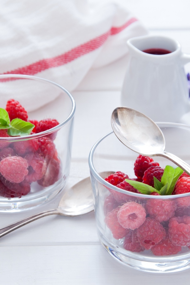 Малина в прозрачный стаканах на завтрак на столе