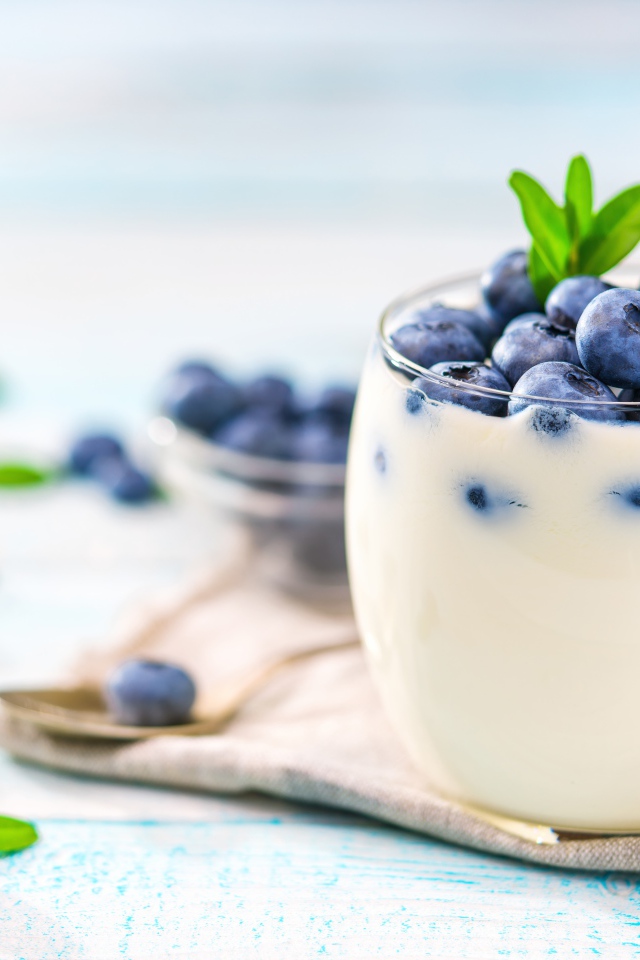 Десерт с йогуртом и ягодами черники с стеклянных стаканах