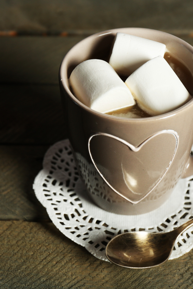 Чашка какао с кусочками маршмеллоу на кружевной салфетке