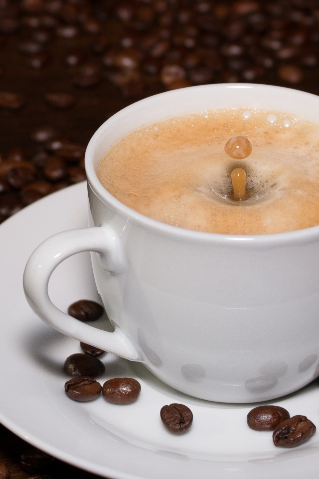 Белая большая чашка кофе с зернами на столе