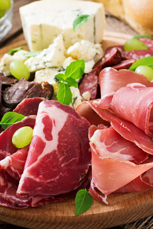 Аппетитная мясная нарезка с сыром на столе 