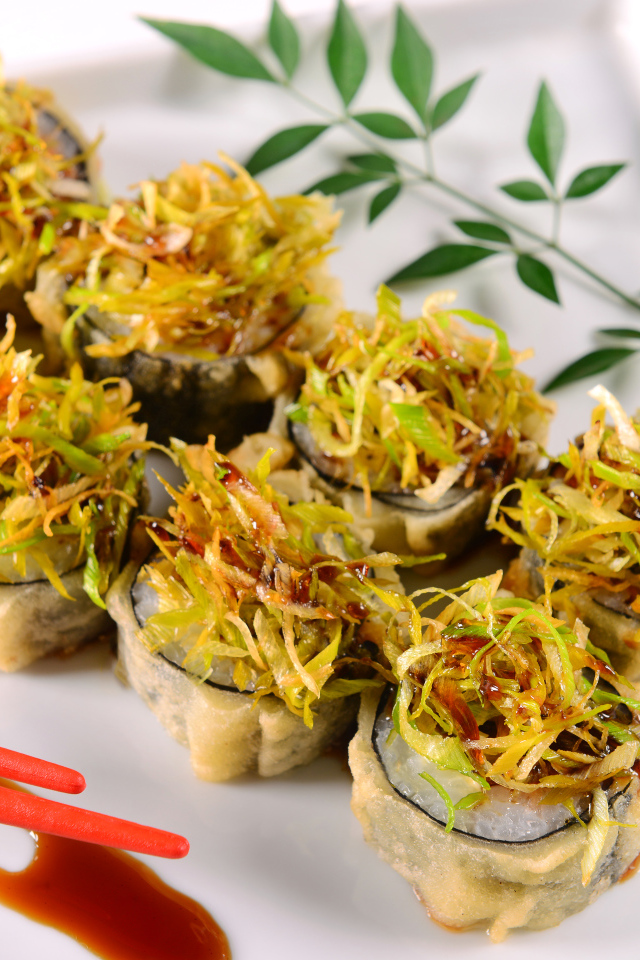 Горячие суши с овощами на белой тарелке 