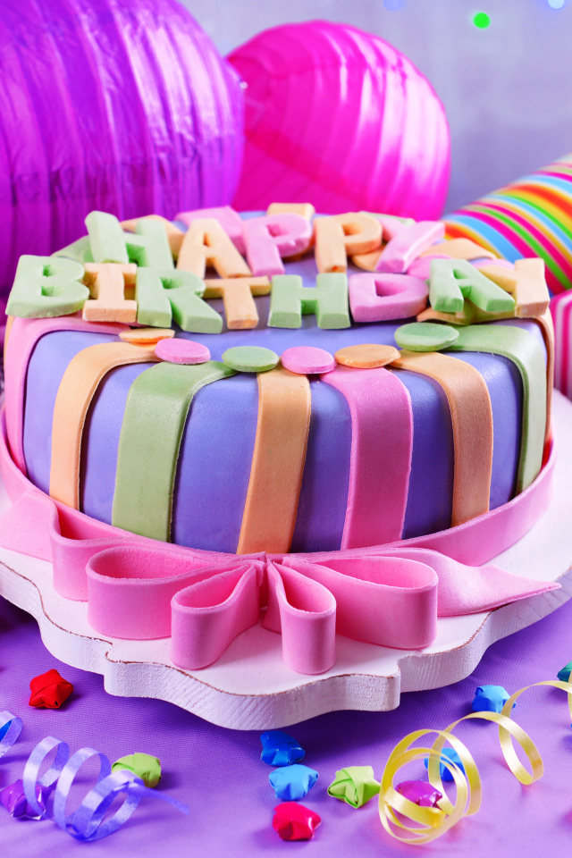 Multicolored cake and decorations for birthday