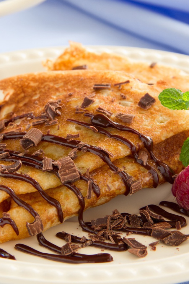 Pancakes with grated chocolate and raspberries