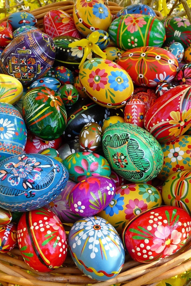 Яркие расписные пасхальные яйца в корзине 