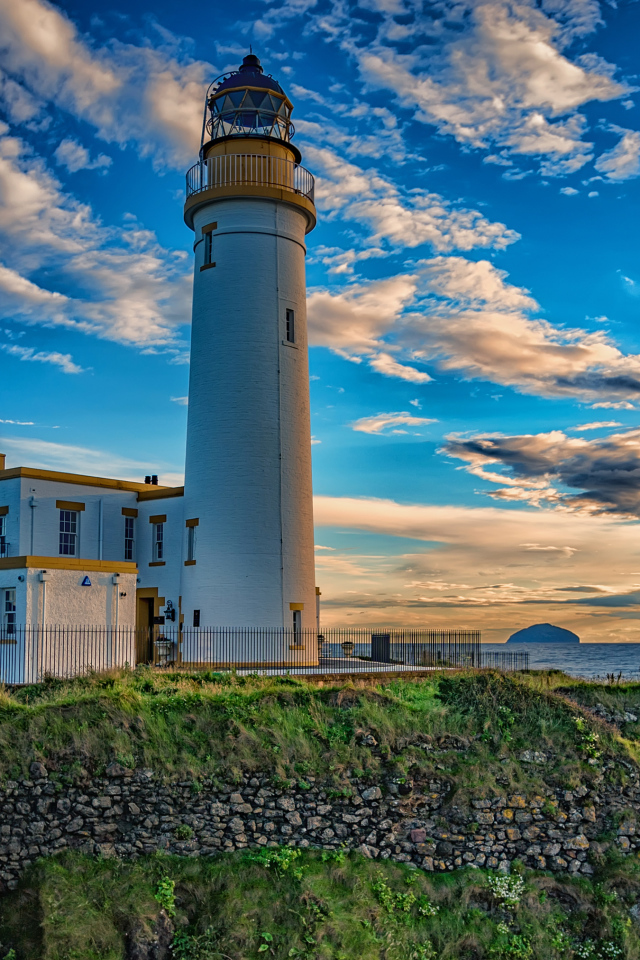 Маяк на побережье под красивым голубым небом