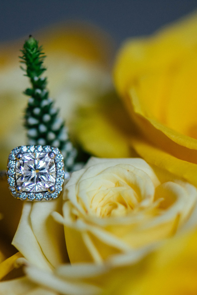 Красивые желтые розы и дорогое кольцо с бриллиантом крупным планом
