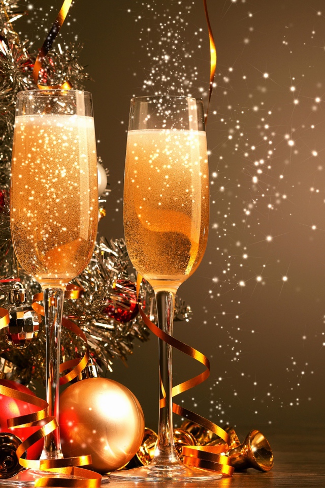 Два фужера с шампанским на фоне праздничной елки