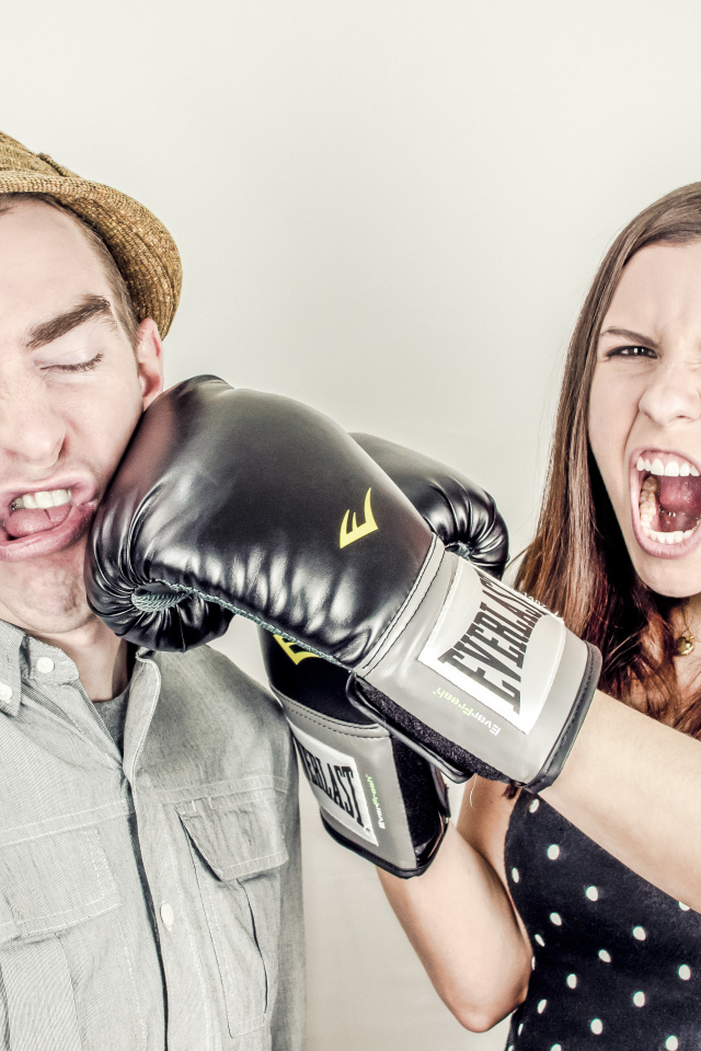 A terrible girl in boxing gloves beats a guy