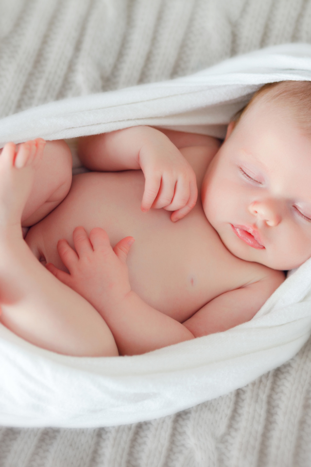 Милый спящий младенец в белом покрывале
