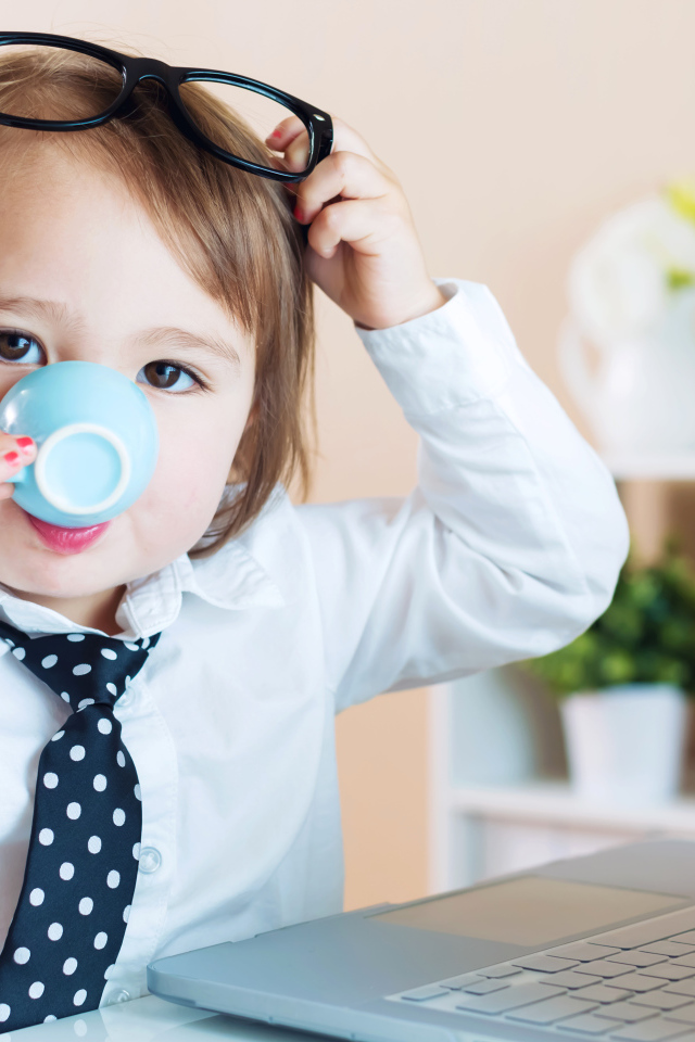 Маленький мальчик в деловом костюме и с чашкой