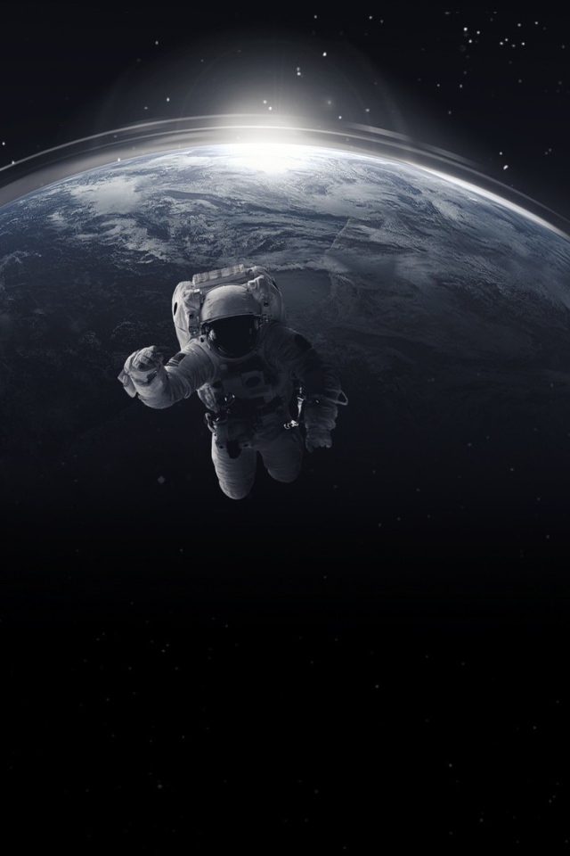 Астронавт в открытом космосе на фоне планеты земля 