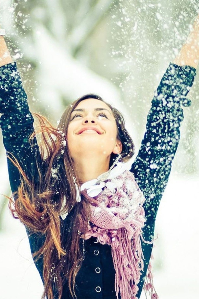 Beautiful girl enjoys snow