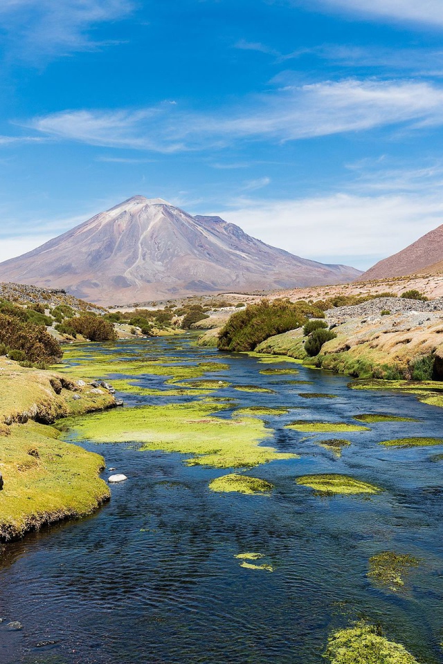 Stratovolcano paneer and mountain river on a background of blue sky, Chile